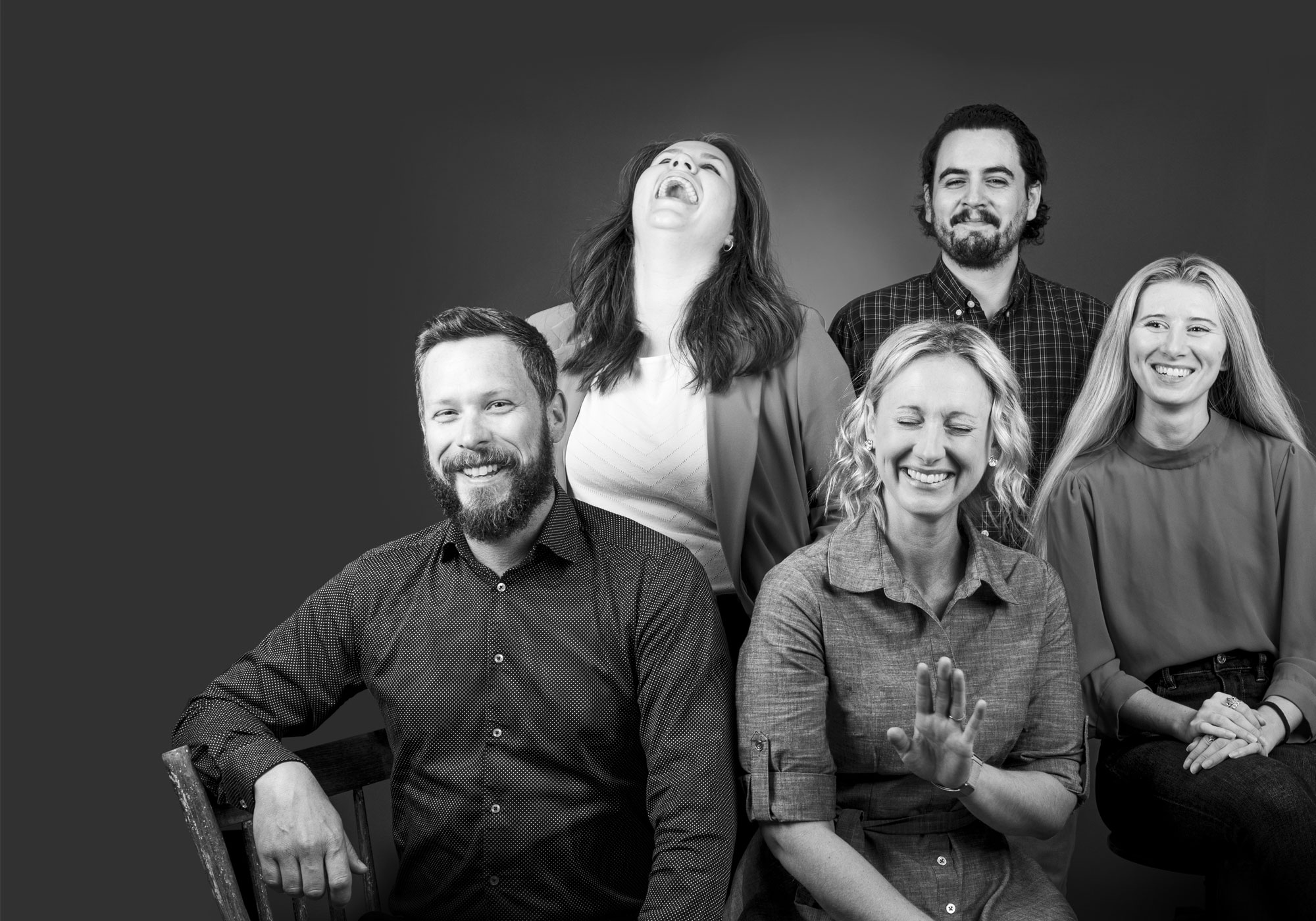 Eric, Laura C, Stacey, Sergio and Megan laughing together during a group photo shot